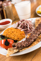 Turkish Adana Kebab with Vegetables on wooden table