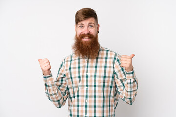Naklejka premium Redhead man with long beard over isolated white background with thumbs up gesture and smiling
