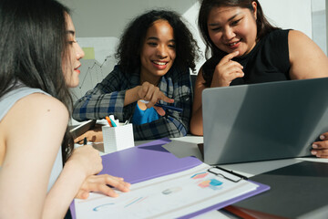 Group of diverse asian and african business women working together in office.