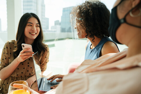 Diversity multi ethnicity women wear face shield in a room.