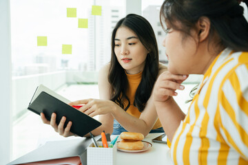 Asian business women working together in office.