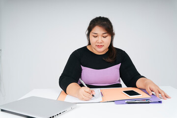 Asian fat business woman working on paper at desk isolate over white background.