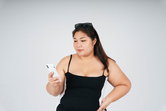 Fat Woman In Black Dress Using Smartphone.