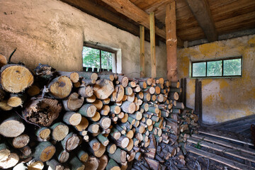 Wnętrze drewutni z zapasami pociętego drewna na zimę.