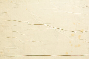 Old weathered beige paper posters with dirty stains glued on billboard texture background.