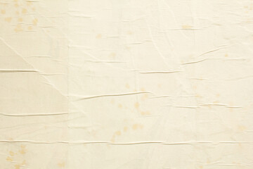 Old beige crumpled paper posters with wavy rough surface and dirty stains texture background.