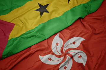 waving colorful flag of hong kong and national flag of sao tome and principe .