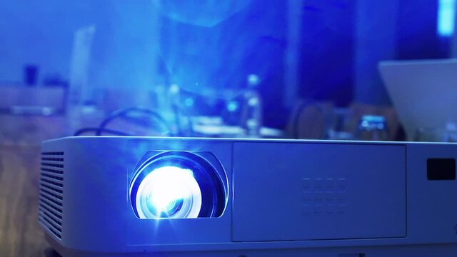 Slow motion shot of a video projector in a conference room. Corporate meeting