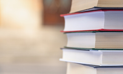Stack of books on the background of school entrance 