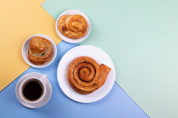 a cup of espresso and cinnamon roll