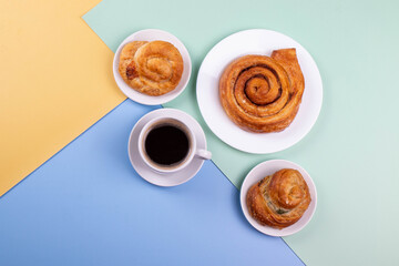 a cup of espresso and cinnamon roll