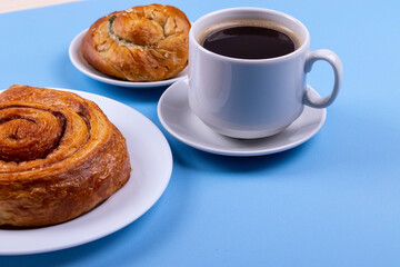 a cup of espresso and cinnamon roll
