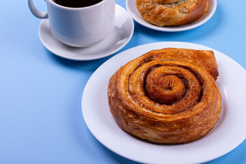 a cup of espresso and cinnamon roll
