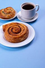 a cup of espresso and cinnamon roll
