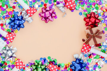 Orange celebration background with gift boxes, colorful party confett.