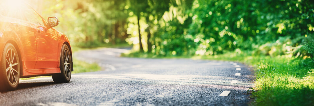 Red Car On Asphalt Road In Summer