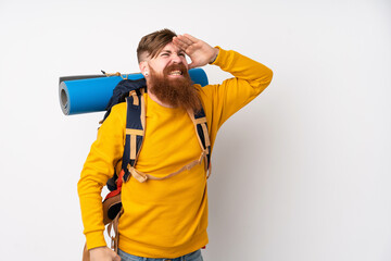 Young mountaineer man with a big backpack over isolated white background