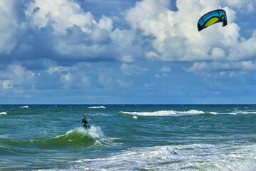 Kitesurfer on the crest of a wave