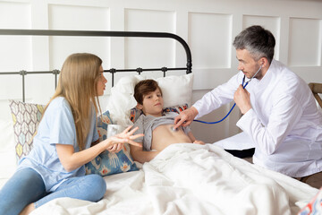 Worried mother consults doctor, physician checkup at home. Children medical insurance care