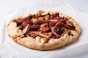 autumn galette with plums and pears. Open cottage cheese dough pie.
