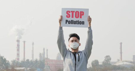 man hold stop pollution sign
