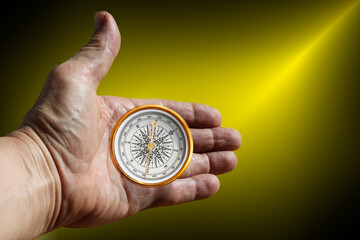 round compass in hand on abstract background as symbol of tourism with compass, travel with compass and outdoor activities with compass