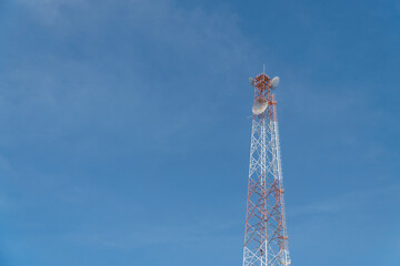 Telecommunication tower with blue sky and cloud in background. Broadcast pole with copy space. Wireless communication technology.