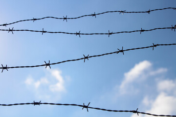 silhouette of wire fences. Sky and clouds