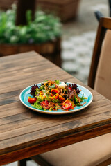 Fresh vegetable salad mix on the wooden table