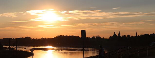 Fototapeta premium Beautiful sunset landscape on the river. Vacation and travel concept. Banner.