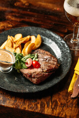 Grilled beef with pepper sauce and potato wedges