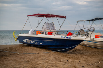 Naklejka premium Small boats for rent, on a beach in Corfu, Greece