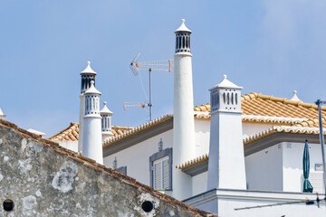 ancient chimney on tiled roofs in Tavira, Algarve, Portugal