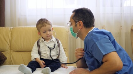 Fototapeta premium Little child with stethoscope consul doctor with uniform, role change, friendly exam