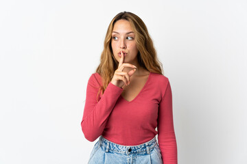 Young blonde woman isolated on blue background showing a sign of silence gesture putting finger in...