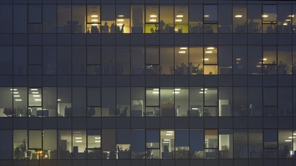 People working late in corporate building at night