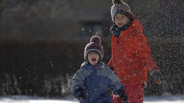 Active Children Play Outside In Winter Park, Child Throw Off Muffler To Toddler, Creative Game, Free Play