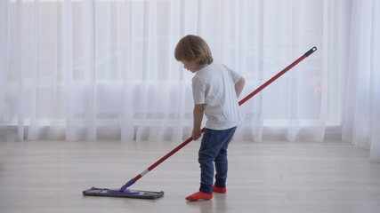 amusing blond hair child rotate with mob in hands, work like dance, conceptual