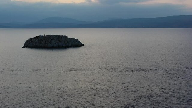 A small island in front of Vlychos Plakes Beach in Hydra Island, Greece