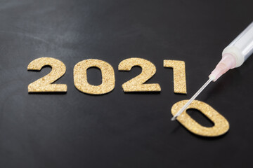 Happy new year 2021 sparkling year lettering black background. 2021 with syringe. 2021 vaccine