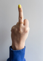 Female hand with extended middle finger