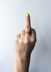 Female hand with extended middle finger