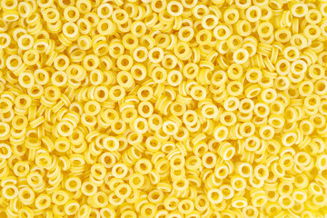 Pasta shaped like rings on white background