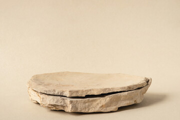 Background for cosmetic products of natural beige color. Stone podium on a white background. Front...