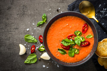 Tomato soup at black table.
