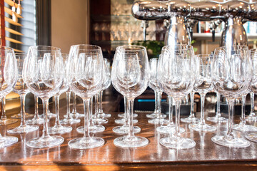 Empty cleaned crystal glasses on a bar.