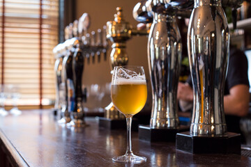 Glass of beer on a pub background.