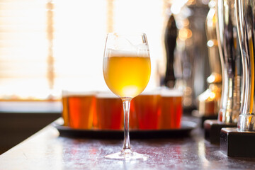 Glasses of light beer on a pub background.