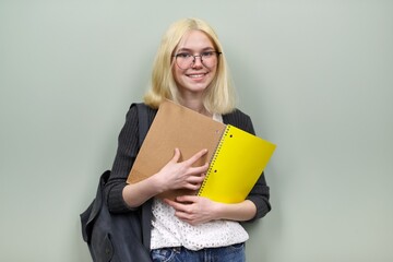 Portrait of happy student girl teenager 16 years old in glasses with backpack