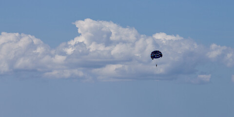 parasailing in clear blue sea.